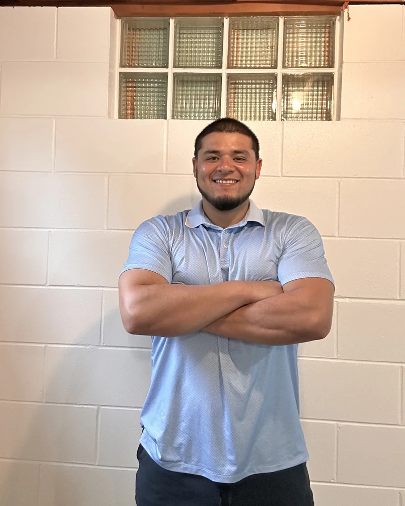 Brandon Landaverde standing with his arms crossed inside the Get Pumped Up studio
